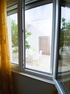 a window with a view of a patio at Gioffredi Apartment in Manduria