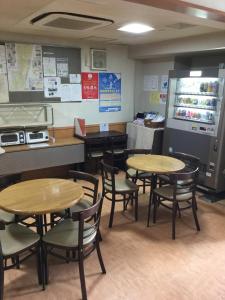 a restaurant with tables and chairs and a counter at City Inn Nishi Tanabe - Vacation STAY 89051v in Osaka