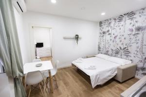 a small bedroom with a bed and a table at Contrasto Apartments in Viterbo