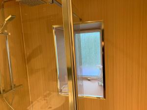 a bathroom with a shower and a glass window at 105 Nelson Street in Largs