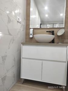 a bathroom with a white sink and a mirror at Bonita y amplia casa con patio, en centro ciudad in Mérida
