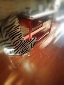 a zebra print chair sitting under a table at Cosy Garden in Maseru