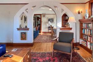 an archway in a living room with a table and a chair at Chic Milwaukee Apartment in Hip Neighborhood! in Milwaukee