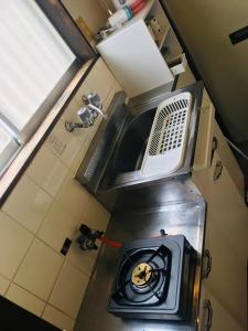an overhead view of a small kitchen with a sink at Garden House Ozasa - Vacation STAY 9178 in Fukuoka