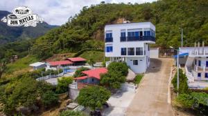 a large white building on top of a hill at Finca Don Matías in Melgar