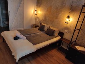 A bed or beds in a room at Napraszállás Vendégház