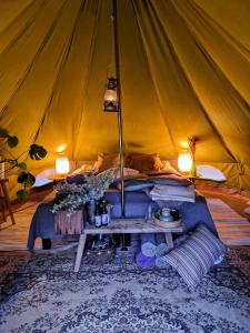 a tent with a cat laying on a couch at Brännskär Cottages & Glamping in Pargas