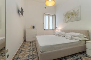 a white bedroom with a bed and a window at ELEGANT APARTMENT IN TAORMINA in Taormina