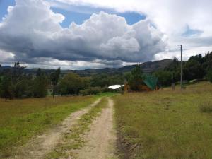 eine unbefestigte Straße mitten auf einem Feld in der Unterkunft Tuminica Lodge - Chalet de montaña en Suesca in Suesca