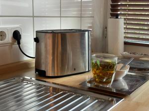 a coffee pot and a cup on a counter in a kitchen at Ferienwohnung Casa Conti Goslar in Goslar