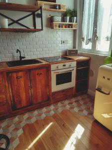 a kitchen with a sink and a stove at B&B San Paolo Sweethome in Parma
