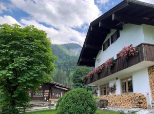 a house with flowers on the balconies of it at Wimbachlehen in Ramsau