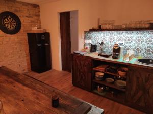 a kitchen with a counter and a refrigerator in it at Napraszállás Vendégház in Balatonakali