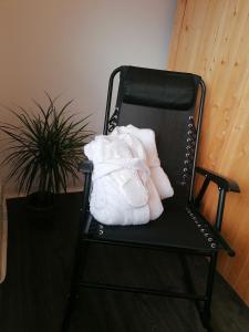a black chair with two white pillows on it at Ferienwohnung Christine mit Sauna und Whirlpool in Utzerath