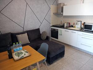 a living room with a couch and a table in a kitchen at Sunset and sea view, wifi and more in Ashkelon