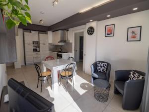 a kitchen and living room with a table and chairs at Casa Felicità in Udine