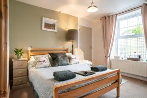 a bedroom with a bed and a window at The Cedars in Builth Wells