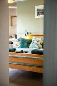 a bed is shown through a door at The Cedars in Builth Wells