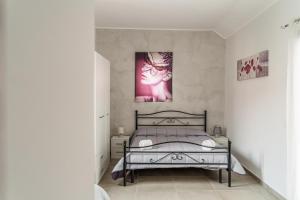 - une chambre avec un lit et une photo de chat dans l'établissement Delia case vacanza, à Fiumefreddo di Sicilia