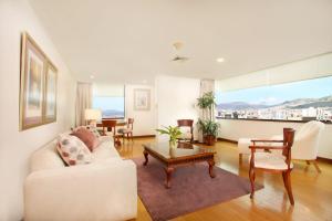 a living room with a white couch and a table at Hotel Rio Amazonas in Quito