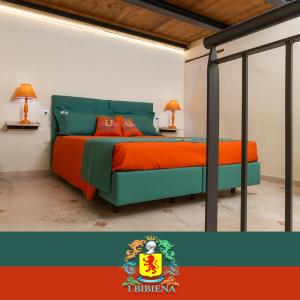 a bedroom with a bed with orange and green at IBibiena - SUITE CECCO E MEA in Bibbiena