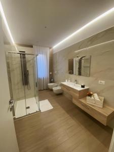 ein Bad mit einer Dusche, einem Waschbecken und einem WC in der Unterkunft Cà Sal Holiday Home in Lesina