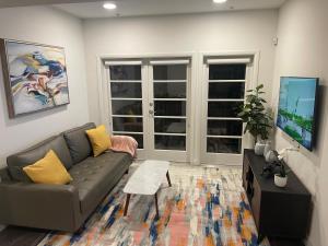 a living room with a couch and a table at Lovely 2/2 apartment in heart of Santa Monica with free parking in Los Angeles