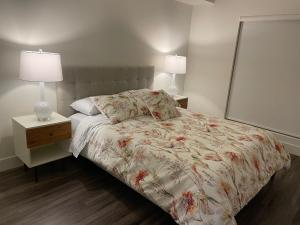 a bedroom with a bed with two lamps on it at Lovely 2/2 apartment in heart of Santa Monica with free parking in Los Angeles