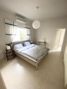 een slaapkamer met een groot bed en een raam bij charming tlv two bedroom in Tel Aviv