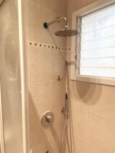 a bathroom with a shower with a shower head at charming tlv two bedroom in Tel Aviv