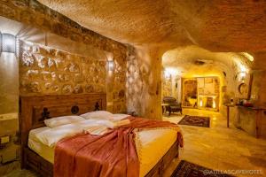 a bedroom with a large bed in a stone room at Atilla's Cave Hotel in Nevsehir