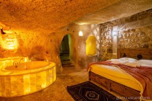 A bed or beds in a room at Atilla's Cave Hotel