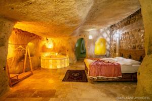 A bed or beds in a room at Atilla's Cave Hotel