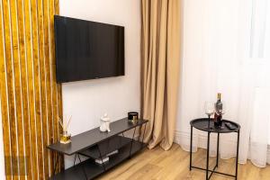 a living room with a flat screen tv on a wall at Urban Nest in Zalău