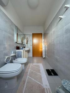 a bathroom with a toilet and a sink at Da Roberto in Falconara Marittima