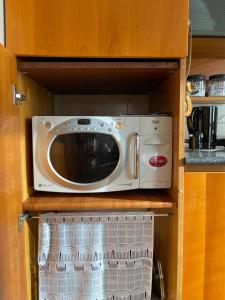 a microwave sitting on a shelf in a kitchen at Da Roberto in Falconara Marittima