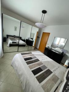 a bedroom with a large bed and a mirror at Da Roberto in Falconara Marittima