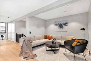 a living room with a couch and a table at Osiris Home in Tromsø