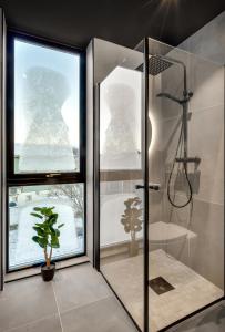 a bathroom with a shower and a potted plant at Osiris Home in Tromsø