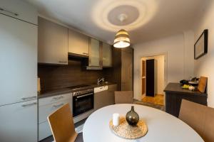 a kitchen and dining room with a white table at Cosy apartment in great Location in Vienna