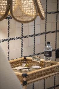 a bottle of water sitting on a table at Privado Selfservice Boutique Rooms in Cartagena de Indias