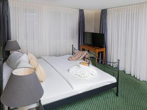 Postel nebo postele na pokoji v ubytování Hotel Rhyhof