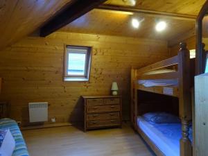 ein Schlafzimmer mit Etagenbetten in einem Blockhaus in der Unterkunft Maison individuelle au Centre du Village 6/8 pers. in Cauterets