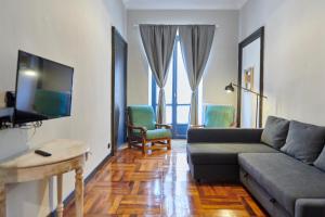 a living room with a couch and a tv at Mazzini 1805 in Turin