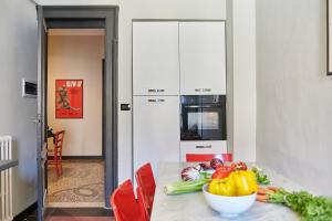 a kitchen with a table with a bowl of vegetables on it at Mazzini 1805 in Turin