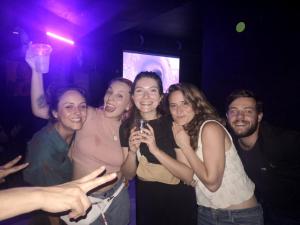 a group of people posing for a picture in a club at Parcerito's Hostel in Jericó