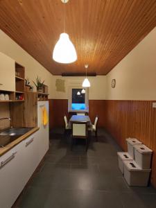 a kitchen with a table and a dining room at Family Hostel Pivka in Pivka