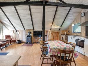 a kitchen and dining room with a table and chairs at 5 person holiday home in Dannemare in Dannemare