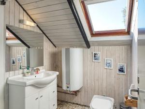 a bathroom with a sink and a toilet with a skylight at 5 person holiday home in Dannemare in Dannemare