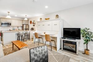 a kitchen and living room with a table and a tv at Sandy Landing in Neskowin